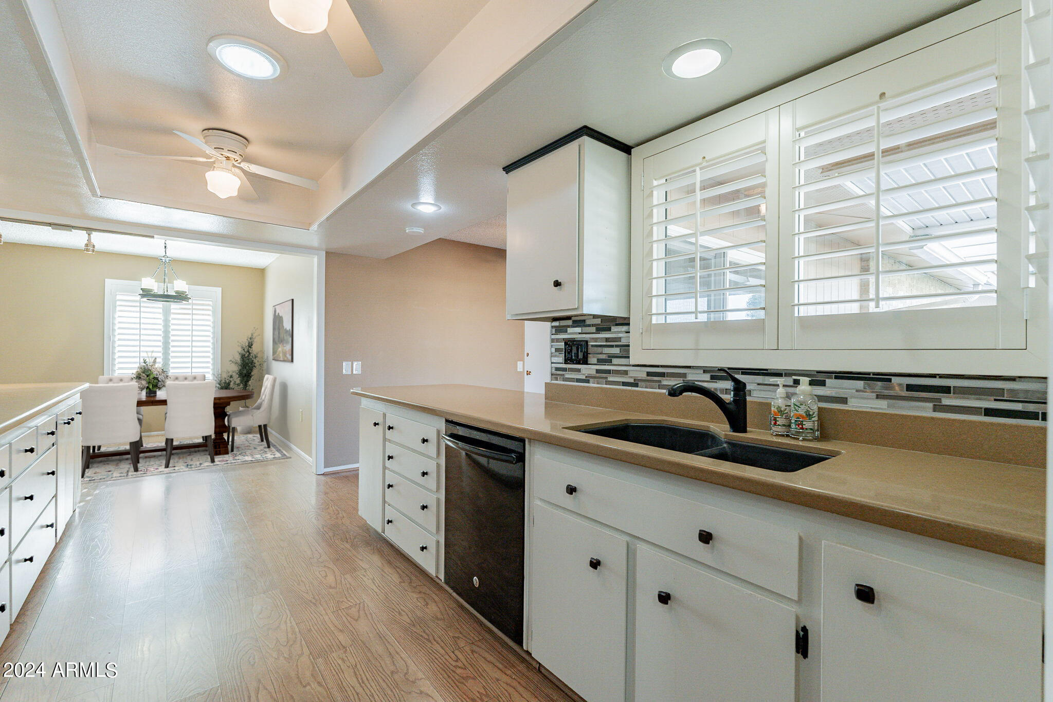 9510 West Greenway Road Sun City, AZ 85351 - Photo 7 of 46 a kitchen with a sink stove and cabinets