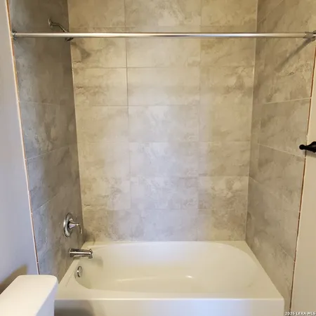 a bathroom with a bath tub and a shower