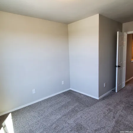 a bathroom with a granite countertop toilet sink and mirror