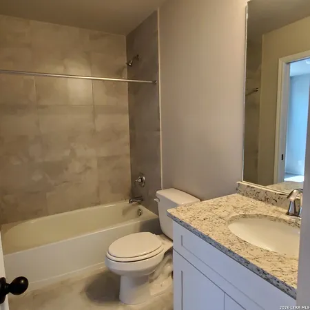 a bathroom with a shower and a bath tub