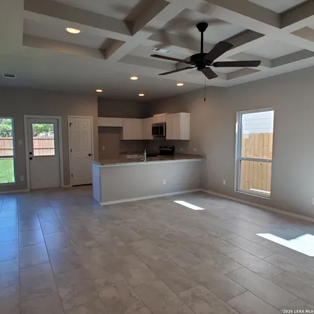 a view of a kitchen with a sink and a stove top oven