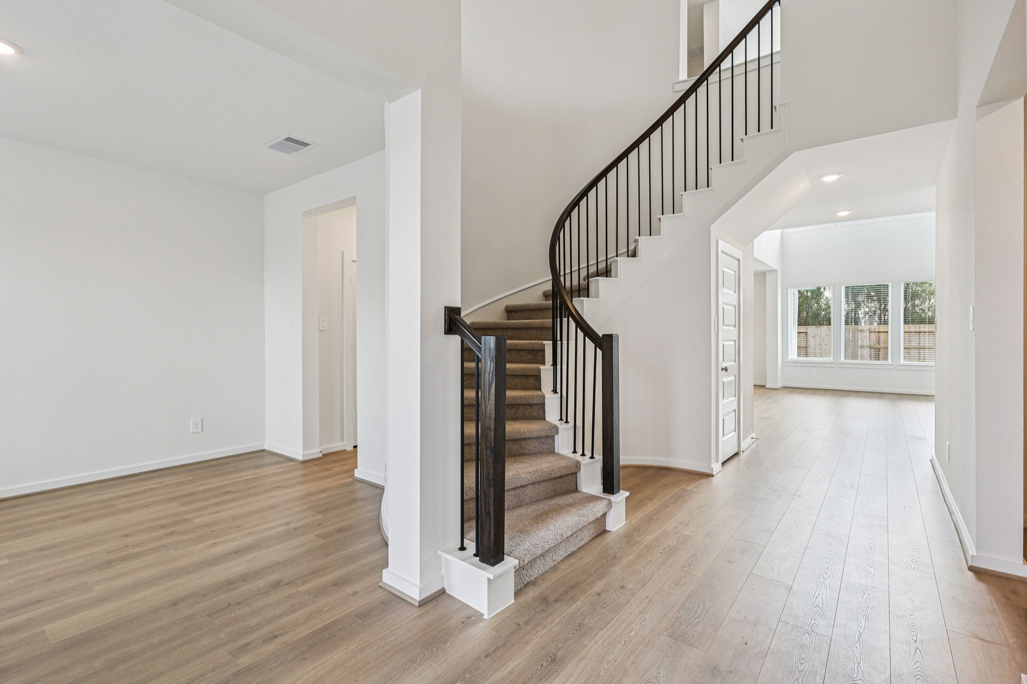 5815 Chamberlain Crossing Rosenberg, TX 77471 - Photo 19 of 35 a view of entryway with wooden floor and stairs