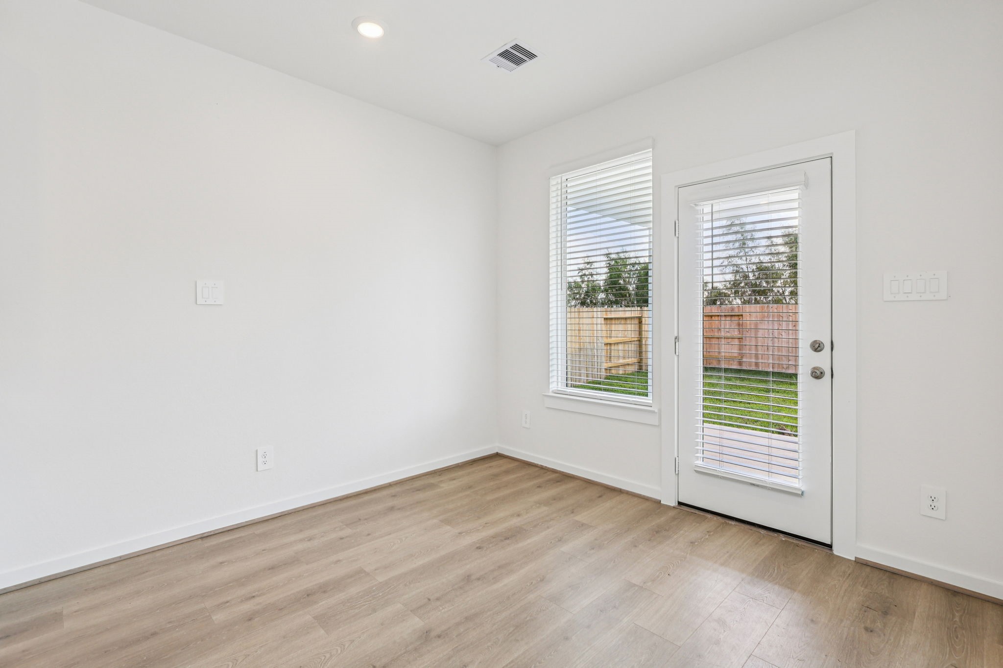 5815 Chamberlain Crossing Rosenberg, TX 77471 - Photo 6 of 35 an empty room with wooden floor and windows