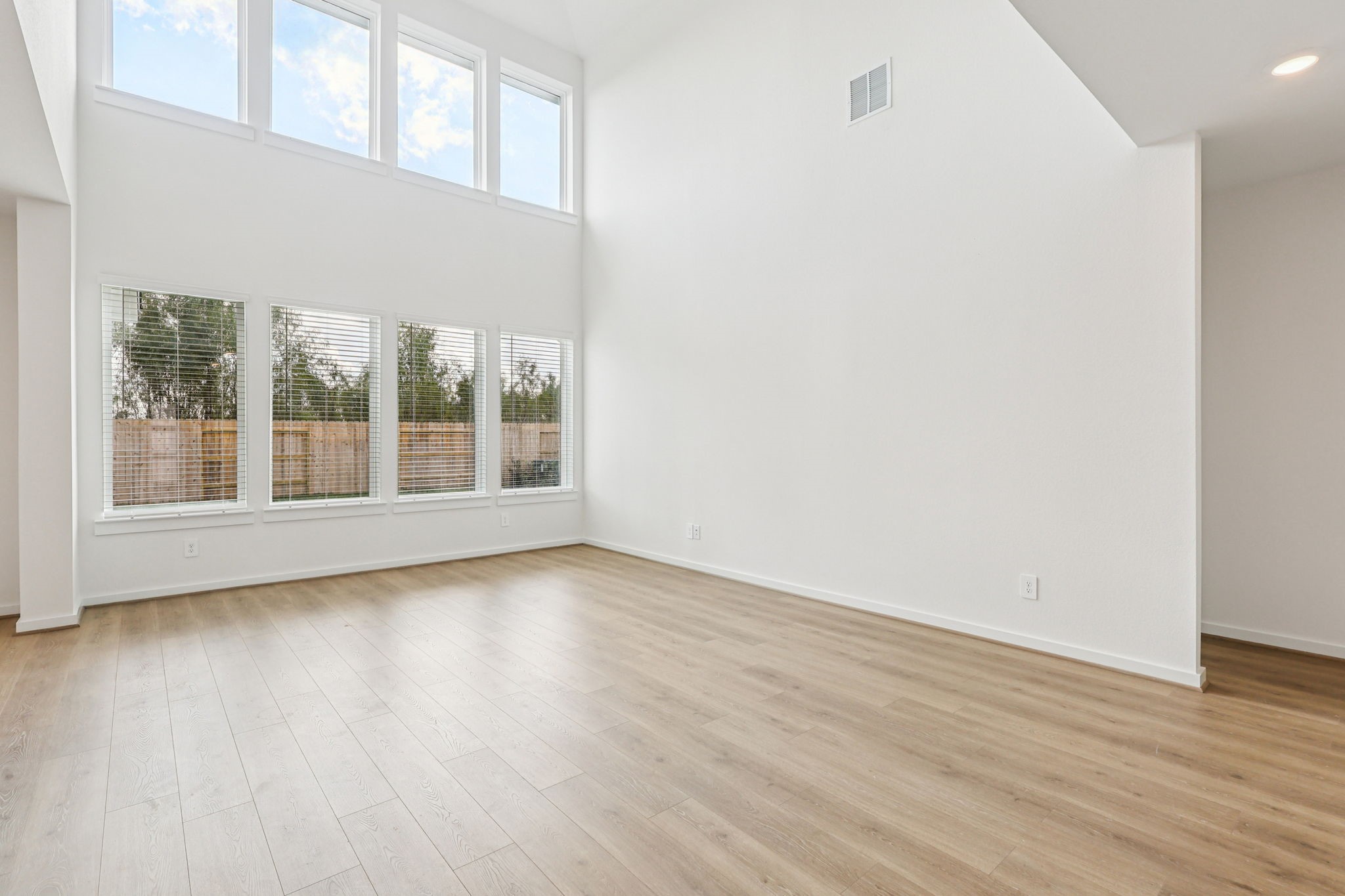 5815 Chamberlain Crossing Rosenberg, TX 77471 - Photo 9 of 35 an empty room with wooden floor and windows