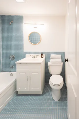 a kitchen with stainless steel appliances kitchen island granite countertop a sink and a white cabinets