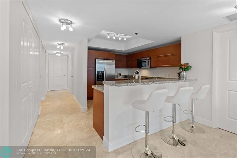 a kitchen with kitchen island a sink stainless steel appliances and cabinets