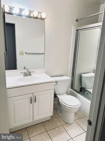 a bathroom with a sink toilet and mirror