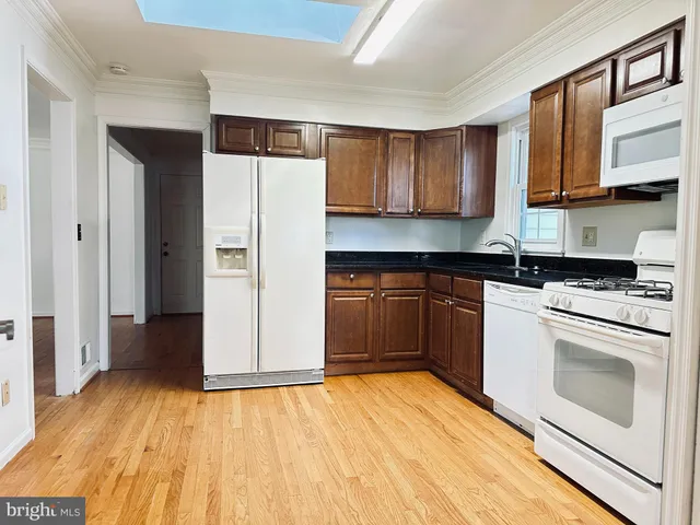 a kitchen with stainless steel appliances granite countertop a stove and a refrigerator
