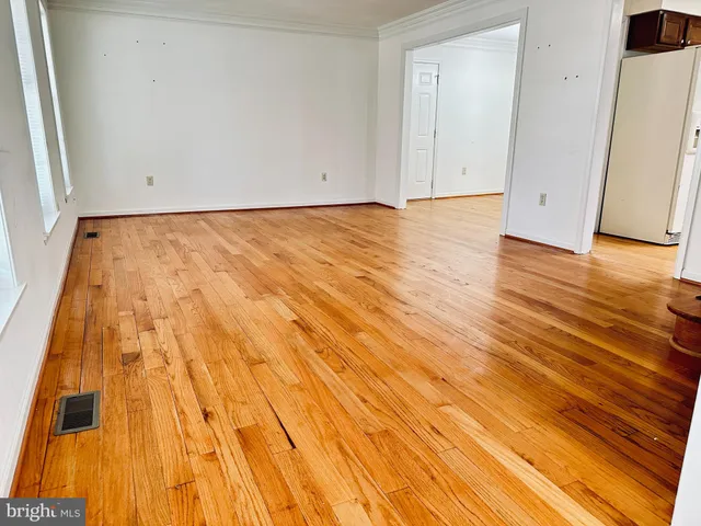a view of room with wooden floor