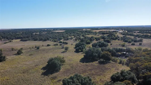 an aerial view of house with a yard