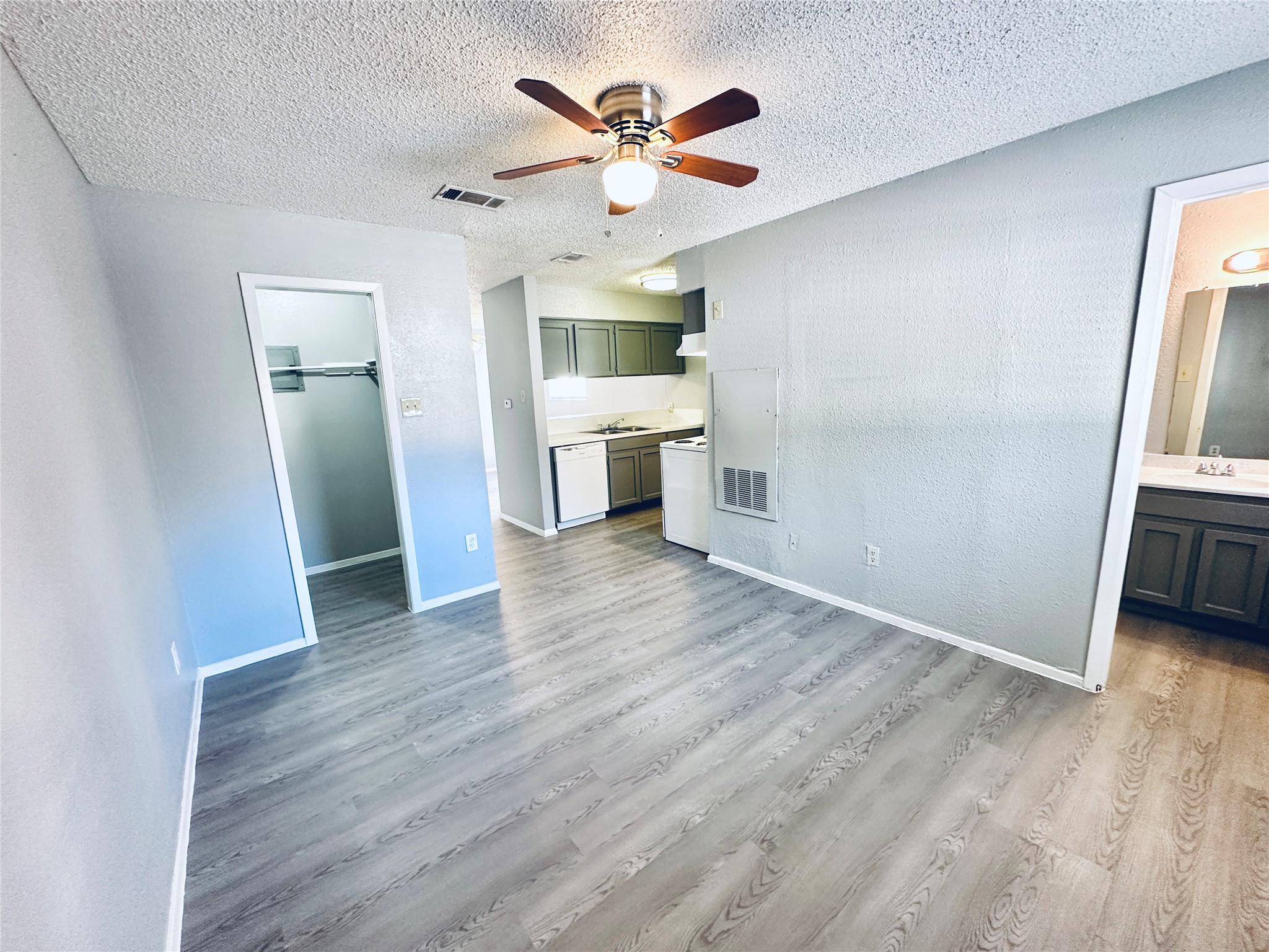 3702 South 2nd Street, Unit 103 Austin, TX 78704 - Photo 11 of 12 wooden floor in an empty room with a kitchen