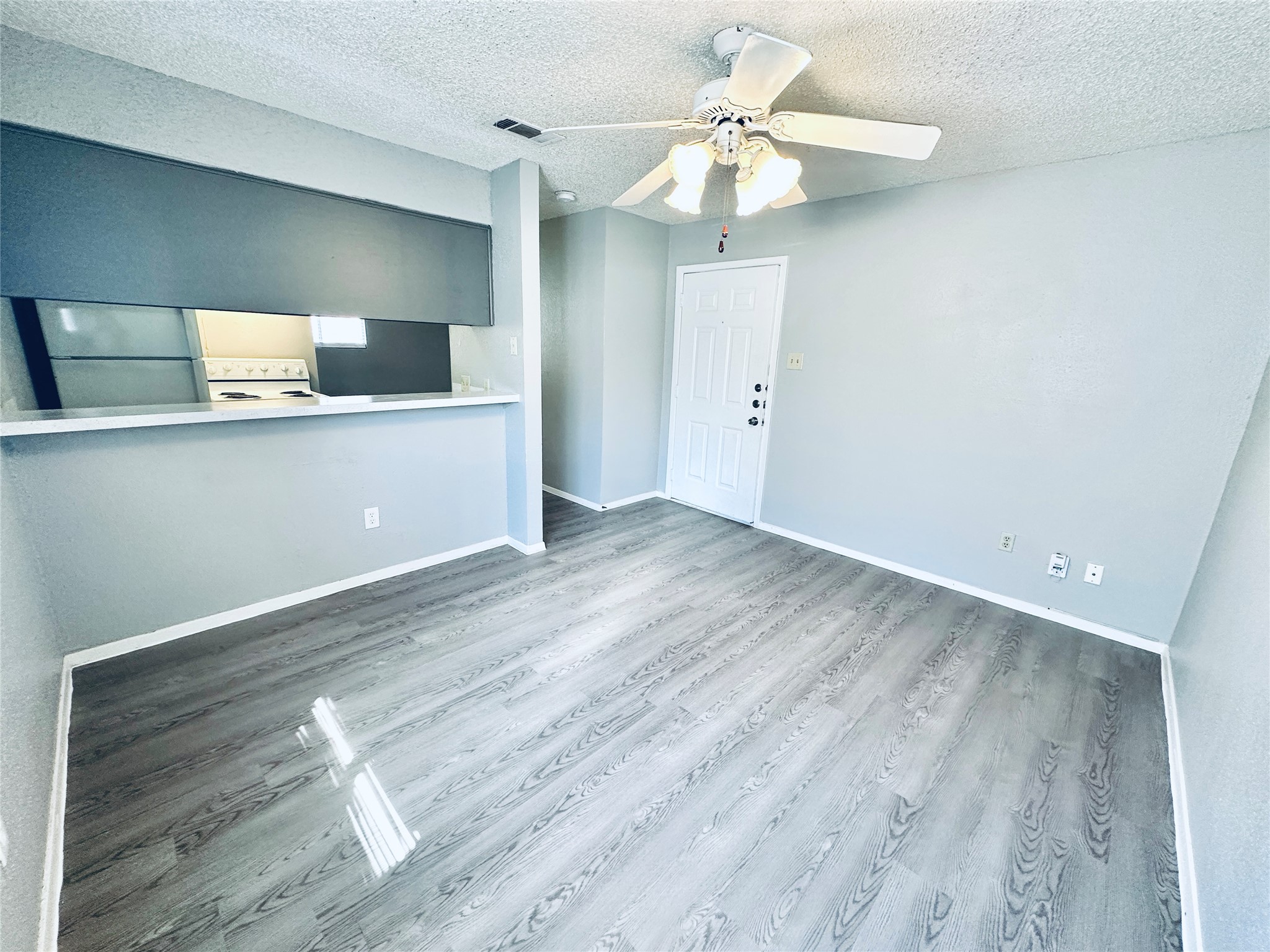 3702 South 2nd Street, Unit 103 Austin, TX 78704 - Photo 2 of 12 wooden floor in an empty room with a window
