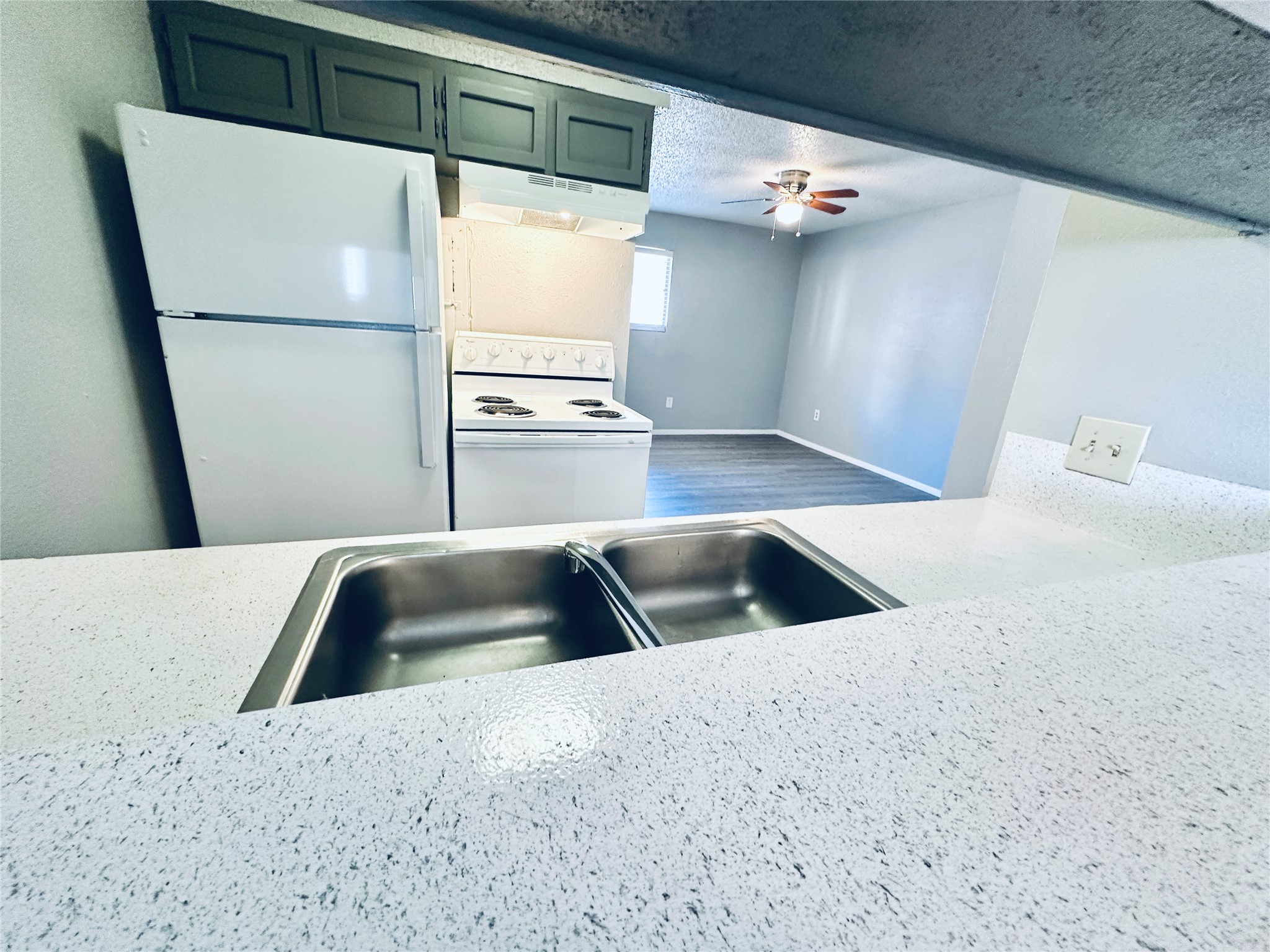 3702 South 2nd Street, Unit 103 Austin, TX 78704 - Photo 5 of 12 a kitchen with a refrigerator and a sink