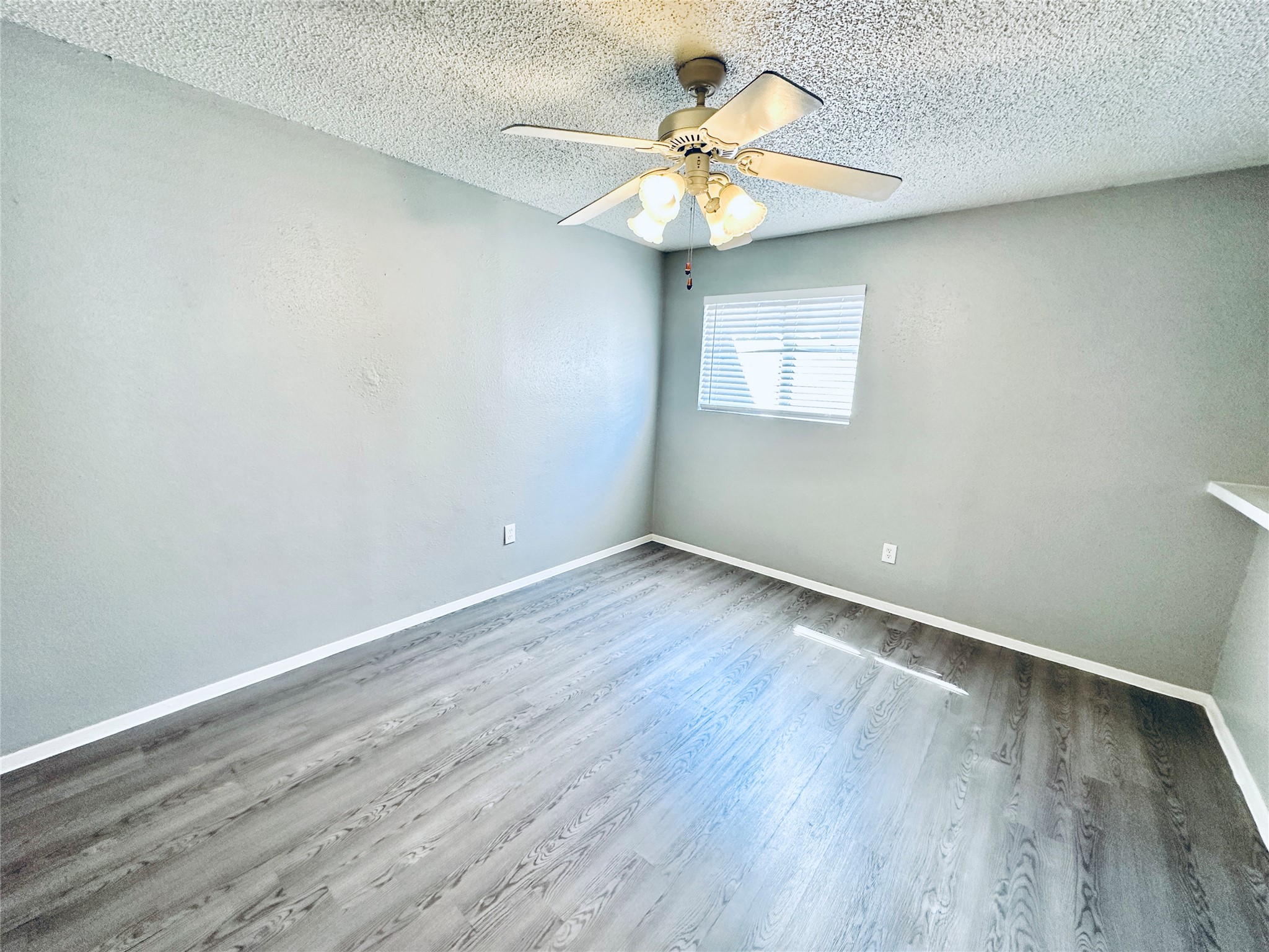 3702 South 2nd Street, Unit 103 Austin, TX 78704 - Photo 9 of 12 wooden floor in an empty room with a window