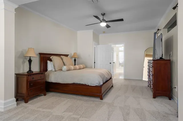 a spacious bedroom with a bed and cabinet