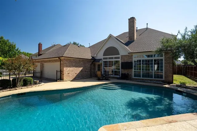 a view of a swimming pool with a yard