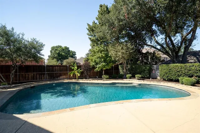an aerial view of a house with yard swimming pool and outdoor seating