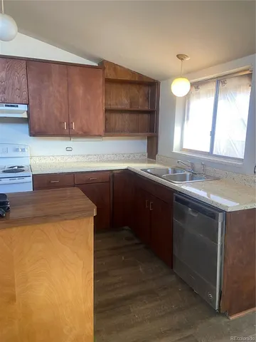 a kitchen with a sink a stove and cabinets