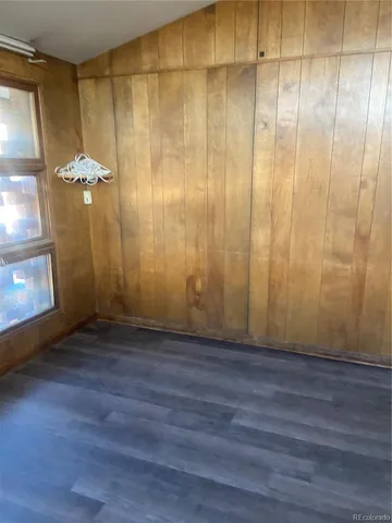 a view of a room with wooden floor and brick walls