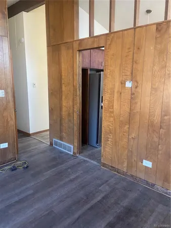 an empty room with wooden floor and a window