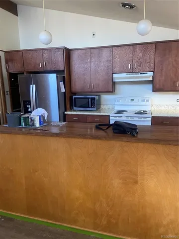 a kitchen with stainless steel appliances a stove refrigerator sink and cabinets