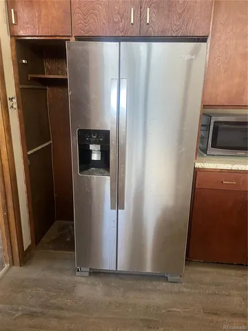 a view of a refrigerator in kitchen