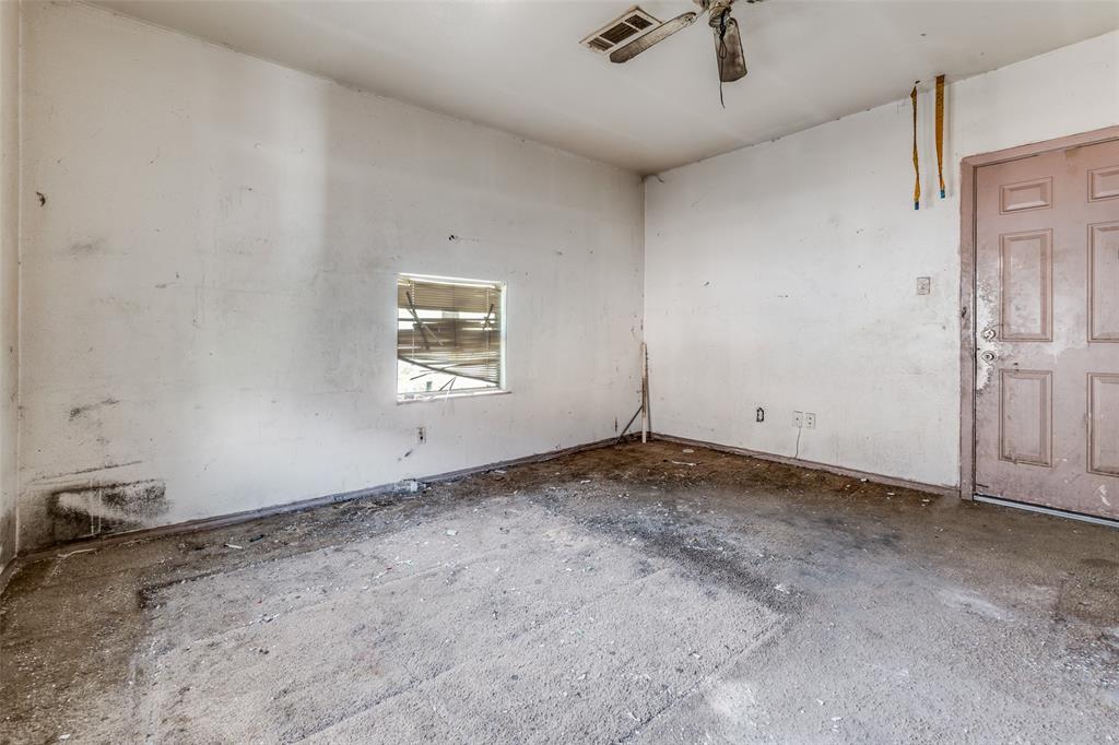 3914 Spence Street Dallas, TX 75215 - Photo 14 of 14 an empty room with a ceiling fan and window