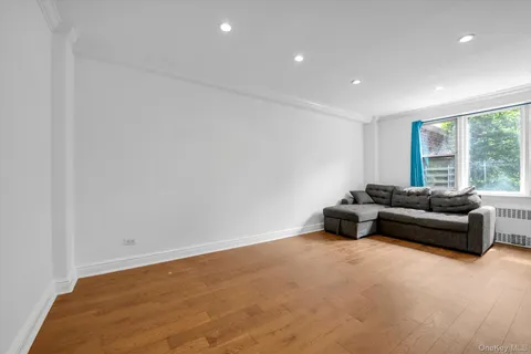 a bedroom with a bed and a refrigerator