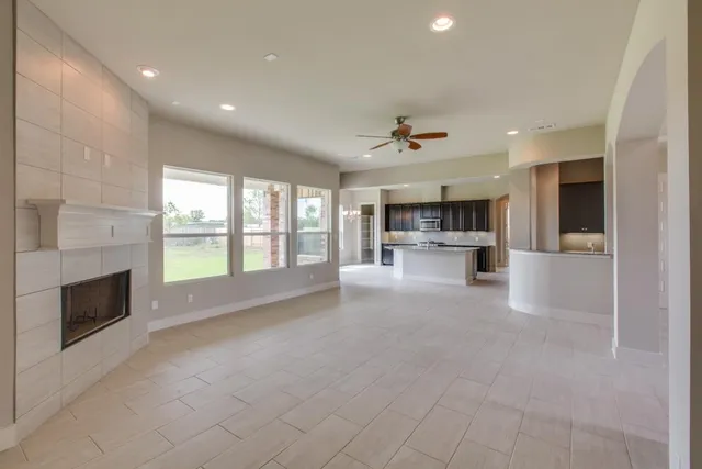 a view of a livingroom with a ceiling fan and window