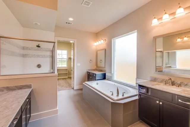 a bathroom with a glass shower door and a shower