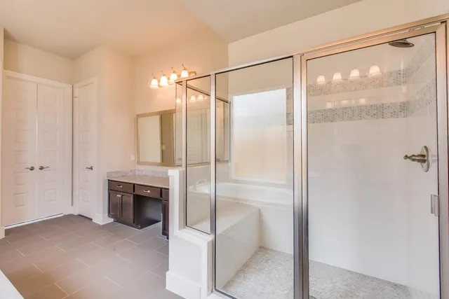 a bathroom with a tub a sink and a mirror