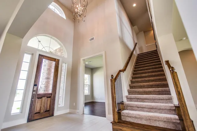 an empty room with windows and cabinet
