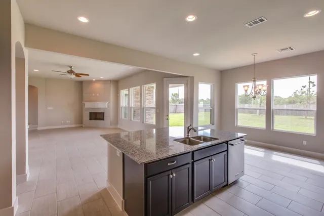 a large kitchen with granite countertop a large counter top and outdoor space