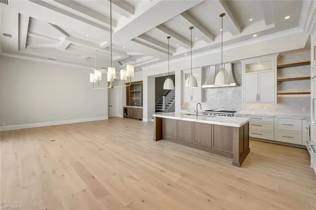 a kitchen with stainless steel appliances kitchen island granite countertop a stove and a refrigerator