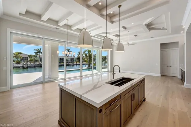a kitchen that has a sink a counter space and a wooden floor