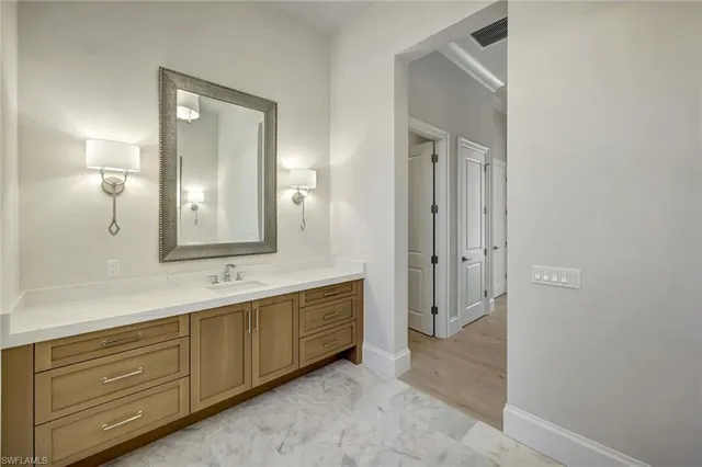 a spacious bathroom with a double vanity sink and a mirror