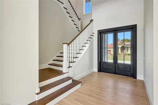 a view of entryway and hall with wooden floor
