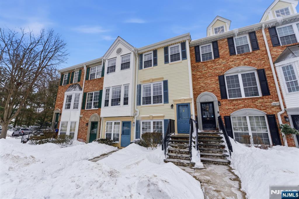 a front view of a building with a yard