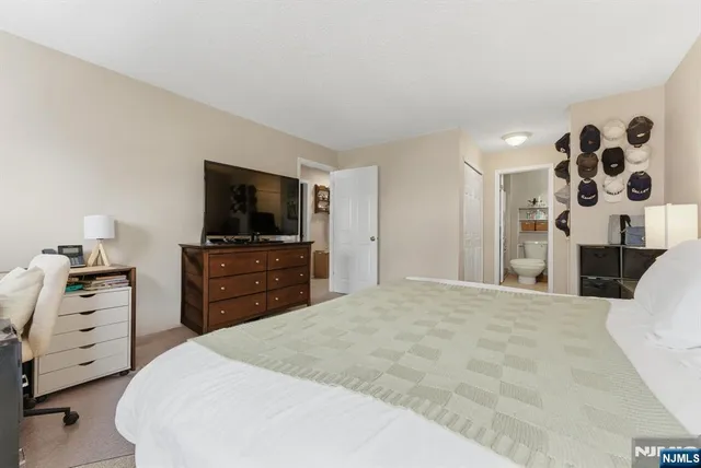 a large white bed in a white room