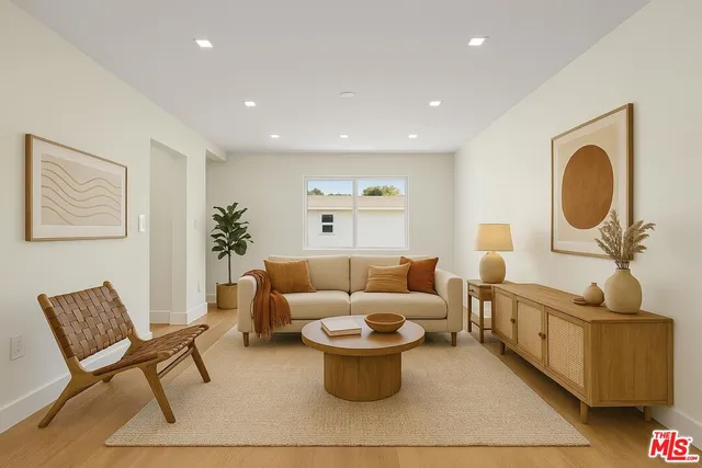 a living room with furniture a rug and a chair