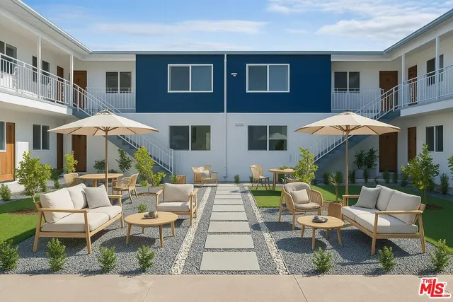 a view of a house with backyard and sitting area