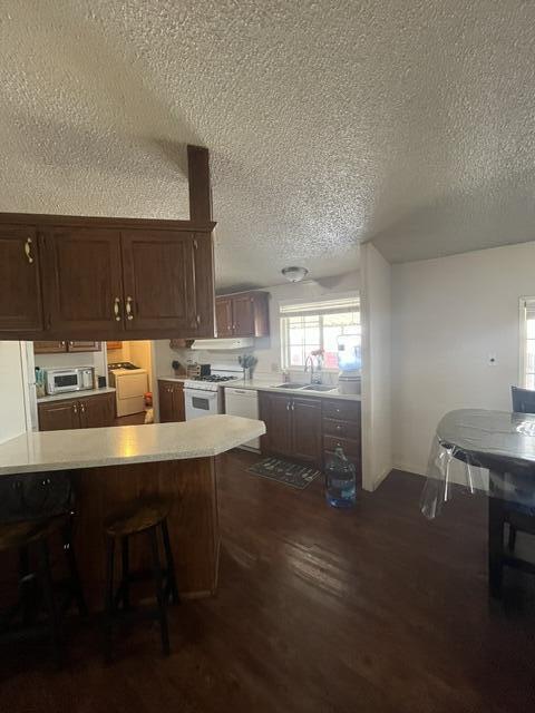 900 East Rankin Road, Unit 110 Tulare, CA 93274 - Photo 3 of 8 a kitchen with a table chairs sink and cabinets