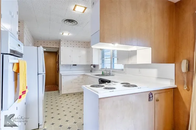 a kitchen with stainless steel appliances a stove a sink and a refrigerator