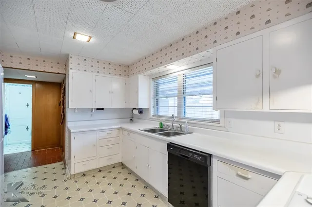a kitchen with a sink stove and cabinets