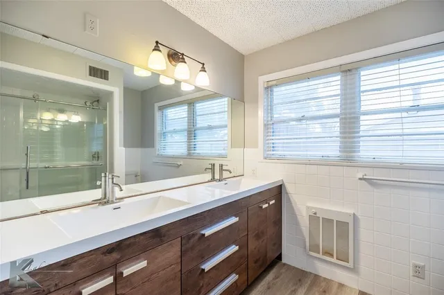 a bathroom with a sink double vanity and window