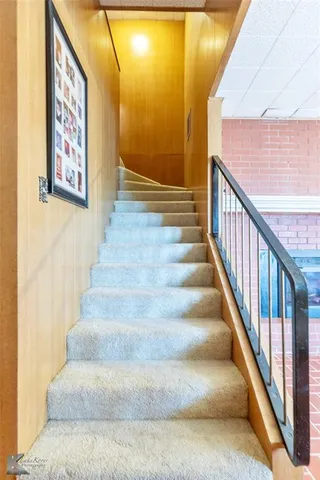 a view of staircase with wooden floor and windows