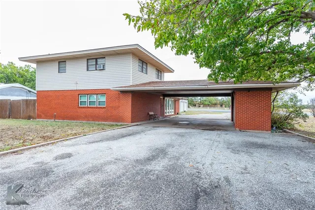 a view of a house with a yard and garage