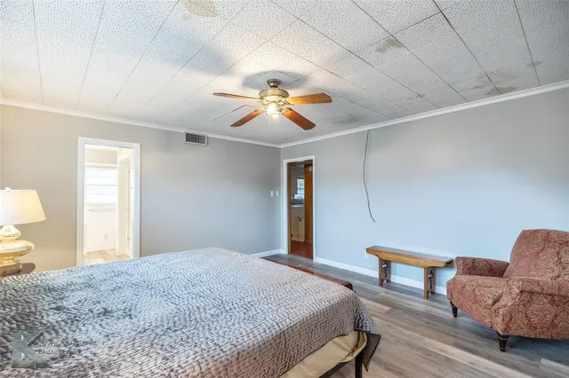 a bedroom with furniture and a chandelier