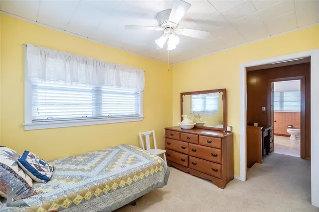 a bedroom with a bed and a table