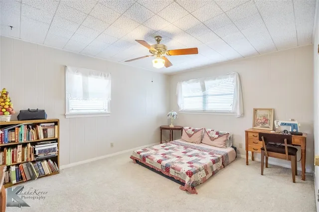 a bedroom with a bed and a book shelf